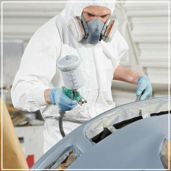 technician painting car bumper