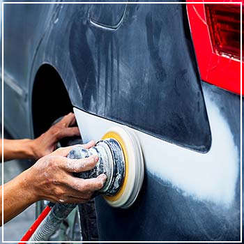 buffing the exterior of a blue car 