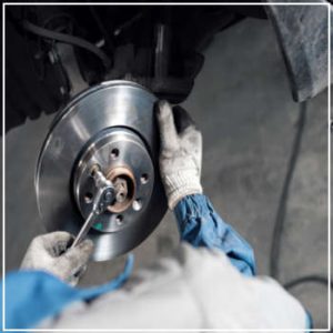 technician repairing brakes