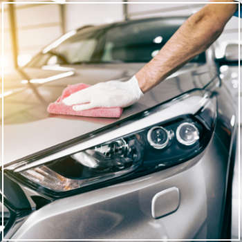 technician waxing a car