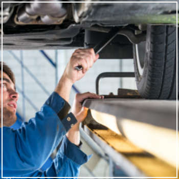 mechanic inspecting suspension