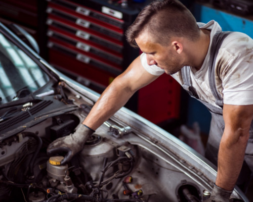 mechanic checking brake fluid