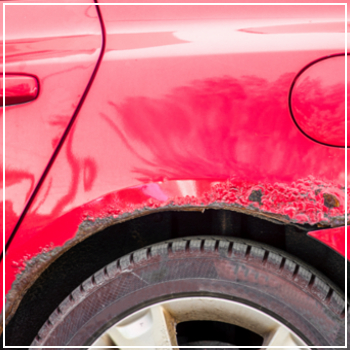 rust damage on red car