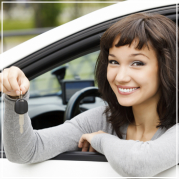 happy young woman holding car keys 