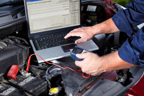 mechanic testing car battery