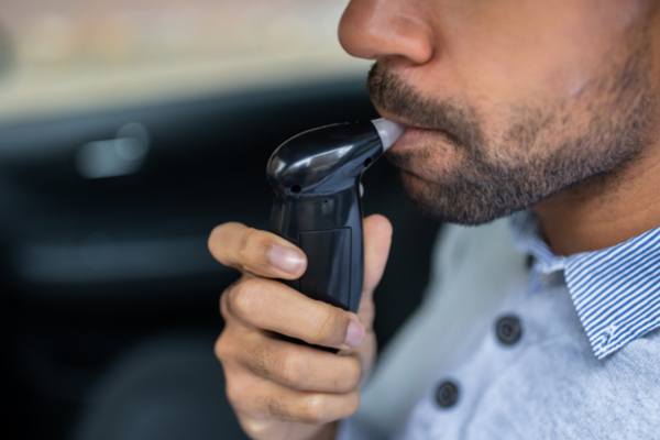 man taking breathalyzer test