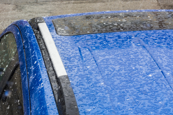 hail hitting blue car