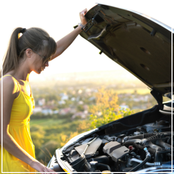 woman looking under car hood