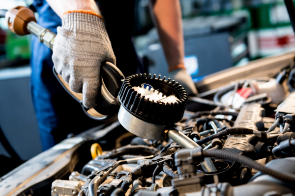 mechanic checking engine oil