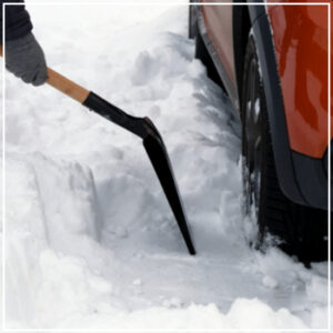 shoveling car out of snow