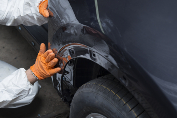 technician examining vehicle for repairs