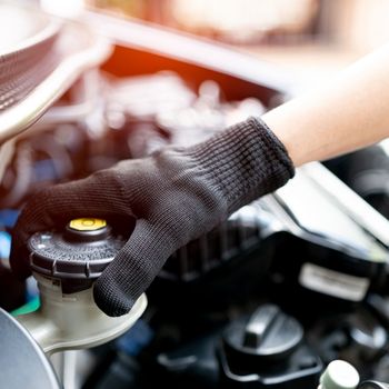 technician checking brake fluid