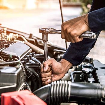 auto mechanic repairing car engine